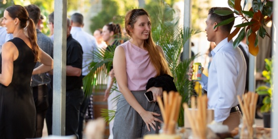 People conversing outside at an event hosted at the MET.