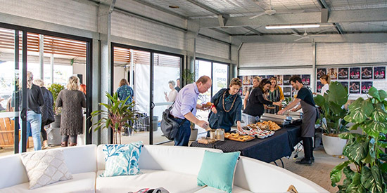 An interior shot of guests enjoying snacks and canapes at an event hosted by The MET.