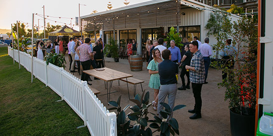 Several groups of people standing together having a drink whilst enjoying an event hosted by The Met